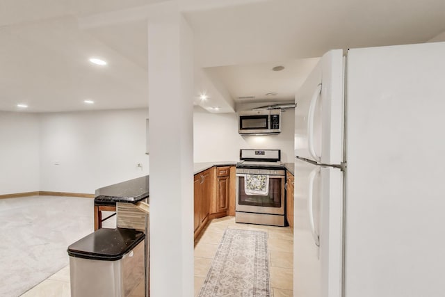 5319 W Cullom Ave, Chicago, IL 60641 - kitchen with stainless steel appliances, brown cabinets, recessed lighting, and light tile patterned flooring
