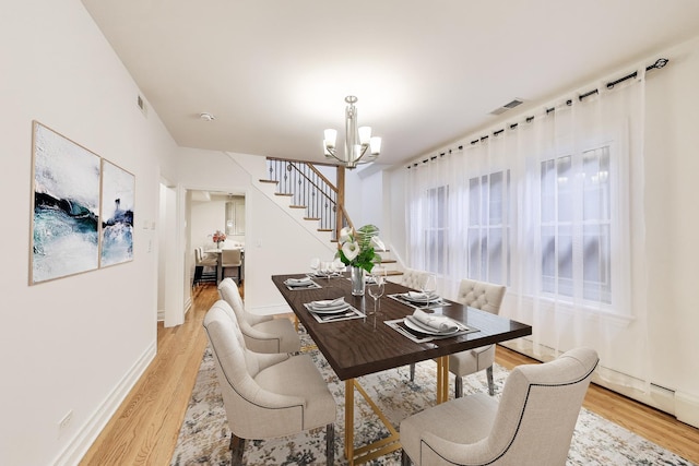 5319 W Cullom Ave, Chicago, IL 60641 - dining room with a chandelier, light wood-style floors, stairway, and baseboards