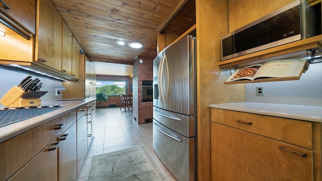 605 N 4th St, Oregon, IL 61061 - kitchen featuring appliances with stainless steel finishes, wood ceiling, light countertops, brown cabinets, and light tile patterned flooring