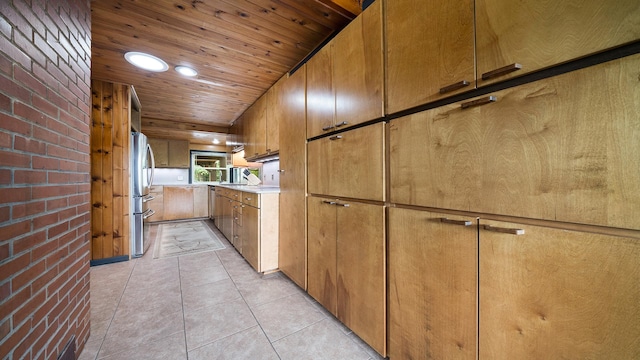 605 N 4th St, Oregon, IL 61061 - kitchen with freestanding refrigerator, wood ceiling, brown cabinetry, light countertops, and light tile patterned flooring