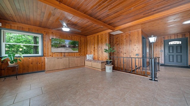 605 N 4th St, Oregon, IL 61061 - spare room with wood walls, wood ceiling with exposed beams, ceiling fan, and tile patterned flooring