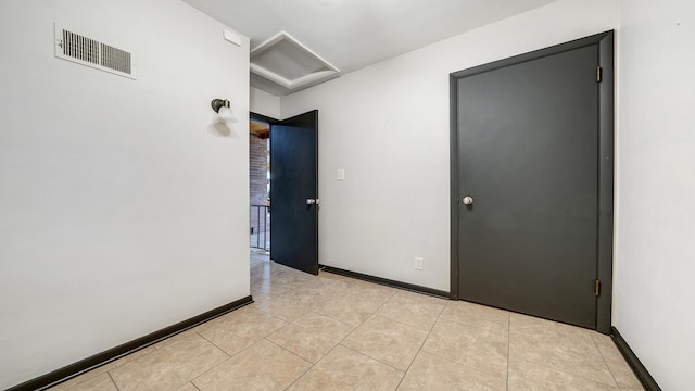 605 N 4th St, Oregon, IL 61061 - spare room with attic access, light tile patterned floors, and baseboards