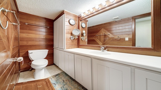605 N 4th St, Oregon, IL 61061 - bathroom with toilet, a textured ceiling, wood walls, and vanity