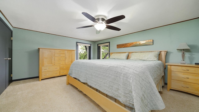 605 N 4th St, Oregon, IL 61061 - bedroom with light colored carpet, ceiling fan, and baseboards