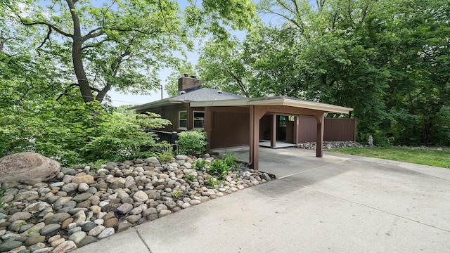 605 N 4th St, Oregon, IL 61061 - view of front of property featuring driveway, an attached carport, and a chimney