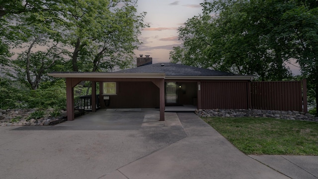605 N 4th St, Oregon, IL 61061 - view of front of home with a chimney, driveway, a carport, a yard, and roof with shingles