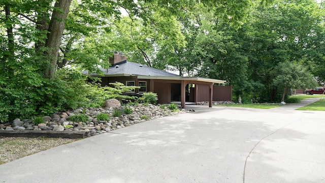 605 N 4th St, Oregon, IL 61061 - view of front of home with driveway, a chimney, and a carport