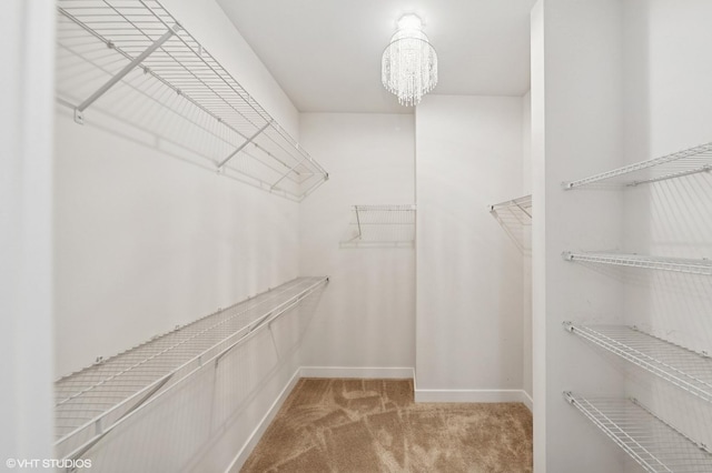 790 Weller Dr, Des Plaines, IL 60016 - walk in closet featuring carpet flooring and a chandelier