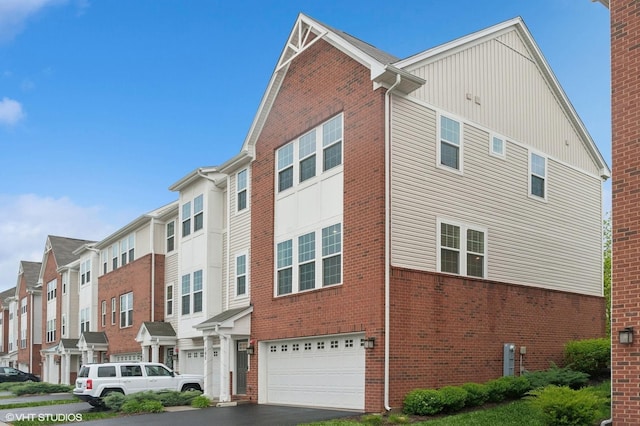 790 Weller Dr, Des Plaines, IL 60016 - view of property with an attached garage, asphalt driveway, and a residential view