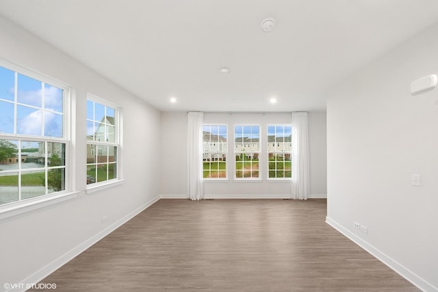 790 Weller Dr, Des Plaines, IL 60016 - unfurnished room featuring wood finished floors, baseboards, plenty of natural light, recessed lighting, and a smoke detector