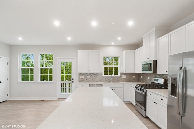 790 Weller Dr, Des Plaines, IL 60016 - kitchen with stainless steel appliances, backsplash, light wood finished floors, recessed lighting, and white cabinets
