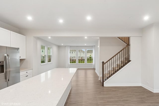 790 Weller Dr, Des Plaines, IL 60016 - kitchen with stainless steel fridge, wood finished floors, recessed lighting, white cabinetry, and light stone countertops