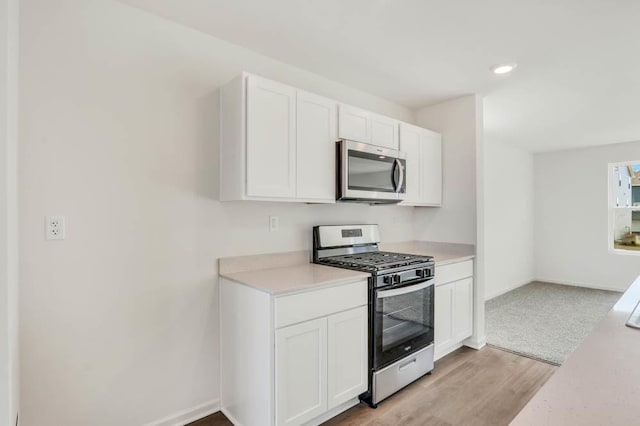 1554 Sequoia Way, Pingree Grove, IL 60140 - kitchen with appliances with stainless steel finishes, light countertops, white cabinetry, baseboards, and light wood-style flooring