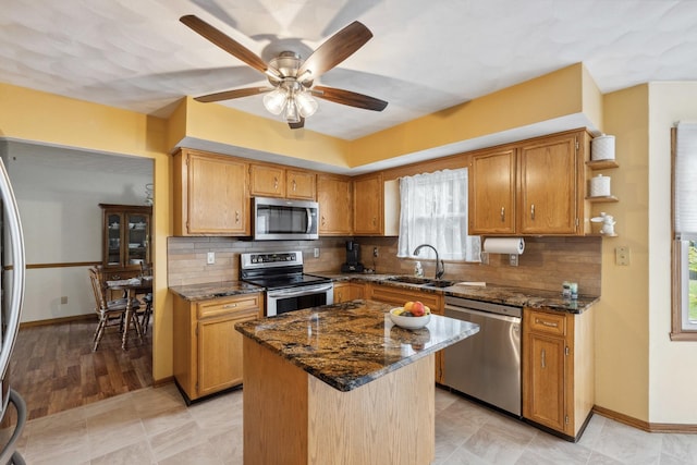 307 Shelden Dr, Winnebago, IL 61088 - kitchen with appliances with stainless steel finishes, a sink, dark stone countertops, a ceiling fan, and open shelves