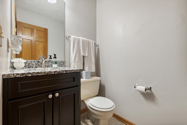 307 Shelden Dr, Winnebago, IL 61088 - bathroom with toilet, vanity, and baseboards