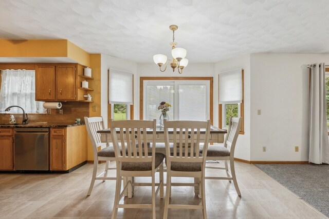 307 Shelden Dr, Winnebago, IL 61088 - dining room featuring a chandelier, plenty of natural light, light tile patterned floors, and baseboards