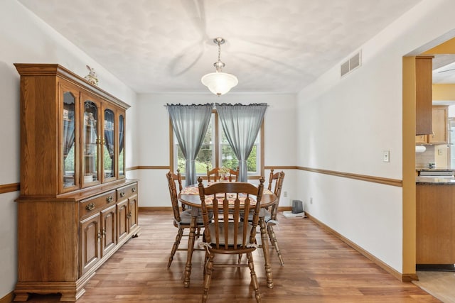 307 Shelden Dr, Winnebago, IL 61088 - dining room featuring light wood-type flooring and baseboards