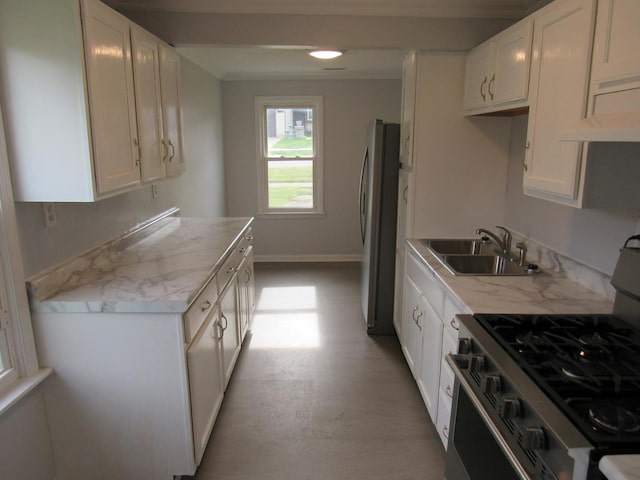 1503 Cherokee Dr, Round Lake Beach, IL 60073 - kitchen with appliances with stainless steel finishes, a sink, range hood, and white cabinetry