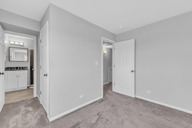 6135 W 94th St Unit C2, Oak Lawn, IL 60453 - unfurnished bedroom featuring carpet flooring, baseboards, a sink, and connected bathroom