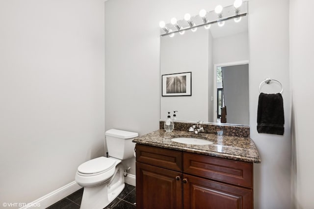 4218 N California Ave, Chicago, IL 60618 - bathroom with baseboards, toilet, and vanity