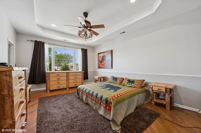 4218 N California Ave, Chicago, IL 60618 - bedroom featuring a tray ceiling, wood finished floors, recessed lighting, baseboards, and a ceiling fan