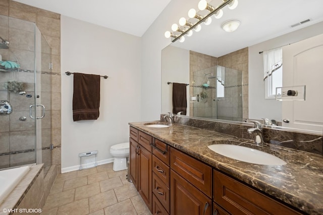 4218 N California Ave, Chicago, IL 60618 - full bathroom featuring double vanity, a stall shower, toilet, baseboards, and tile patterned floors