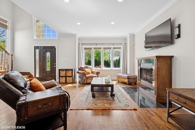 4218 N California Ave, Chicago, IL 60618 - living room with wood finished floors, ornamental molding, healthy amount of natural light, a fireplace, and stairs