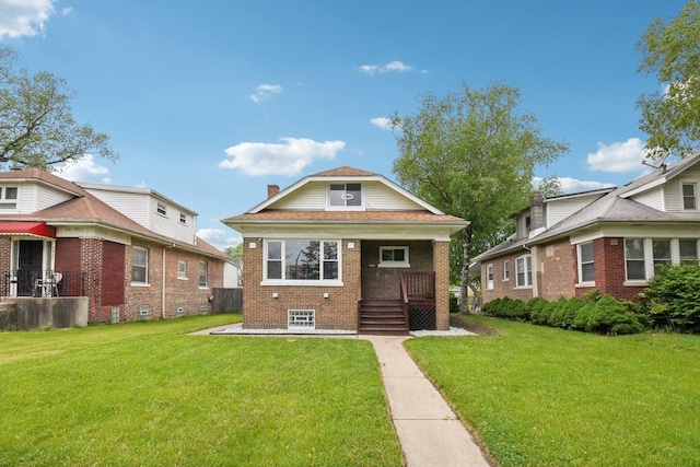 8428 S Rhodes Ave, Chicago, IL 60619 - bungalow-style home with brick siding, a porch, and a front lawn