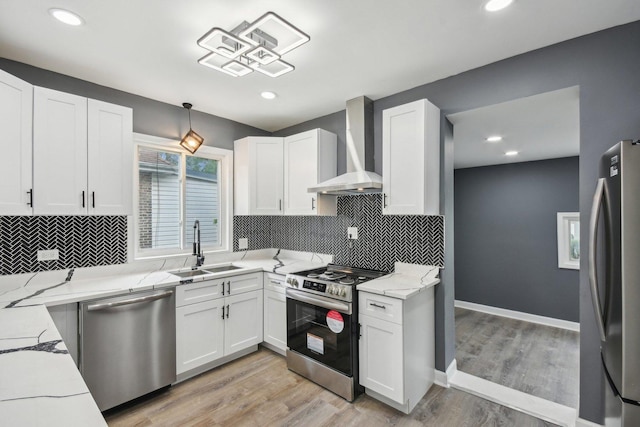 8428 S Rhodes Ave, Chicago, IL 60619 - kitchen featuring stainless steel appliances, wall chimney range hood, a sink, white cabinetry, and recessed lighting