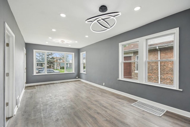 8428 S Rhodes Ave, Chicago, IL 60619 - unfurnished room featuring wood finished floors, recessed lighting, baseboards, and a chandelier