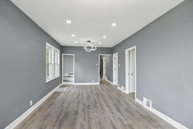 8428 S Rhodes Ave, Chicago, IL 60619 - spare room with recessed lighting, wood finished floors, and baseboards