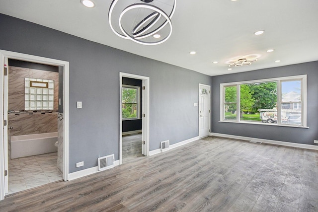 8428 S Rhodes Ave, Chicago, IL 60619 - unfurnished living room with plenty of natural light, recessed lighting, baseboards, and wood finished floors