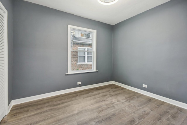 8428 S Rhodes Ave, Chicago, IL 60619 - spare room featuring wood finished floors and baseboards