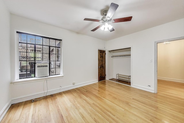 7350 N Ridge Blvd Unit 21B, Chicago, IL 60645 - unfurnished bedroom with wood finished floors, a closet, baseboards, a ceiling fan, and cooling unit