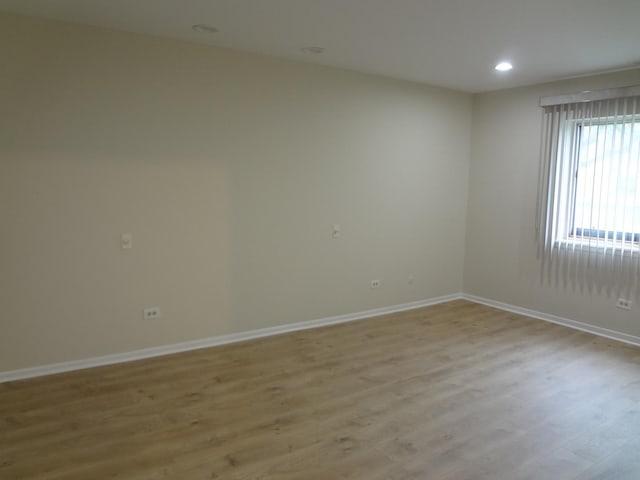 1108 Castilian Ct Unit 121, Glenview, IL 60025 - spare room featuring light wood-style flooring, baseboards, and recessed lighting