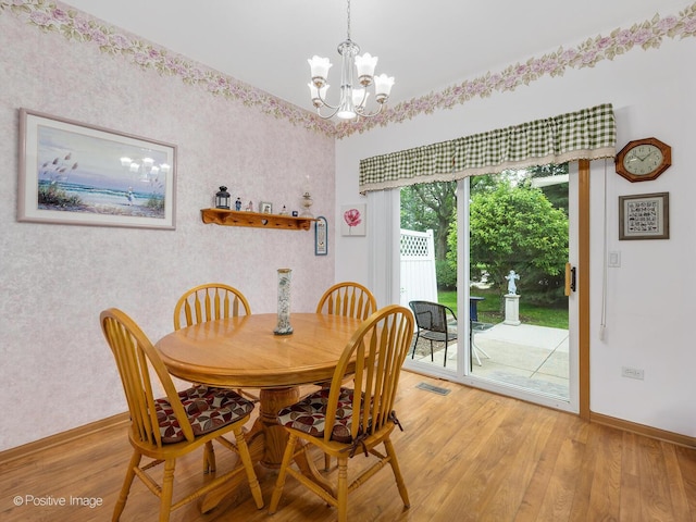 21142 W Braxton Ln Unit 21142, Plainfield, IL 60544 - dining space with baseboards, light wood-type flooring, a chandelier, and wallpapered walls