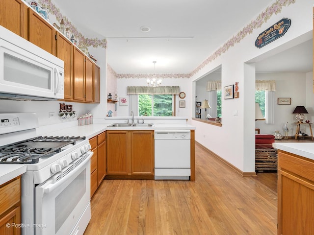 21142 W Braxton Ln Unit 21142, Plainfield, IL 60544 - kitchen featuring white appliances, a sink, a chandelier, and light wood finished floors