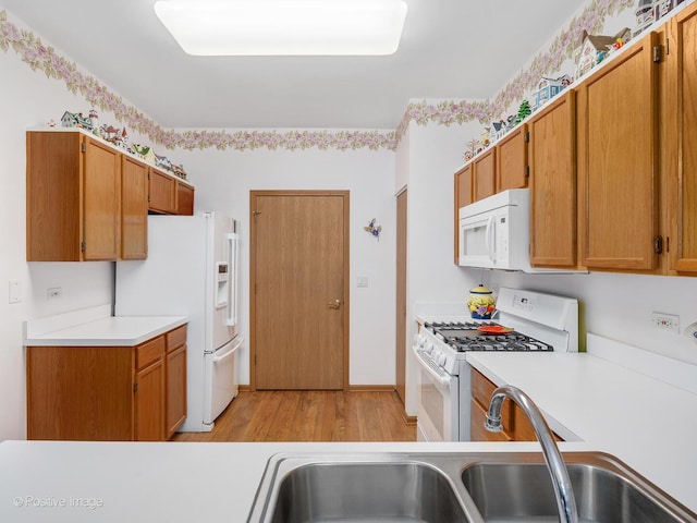 21142 W Braxton Ln Unit 21142, Plainfield, IL 60544 - kitchen featuring white appliances, light countertops, light wood-style floors, and brown cabinetry