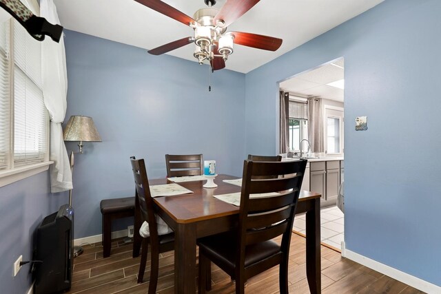 14453 Kolin Ave, Midlothian, IL 60445 - dining room featuring wood finished floors, ceiling fan, and baseboards