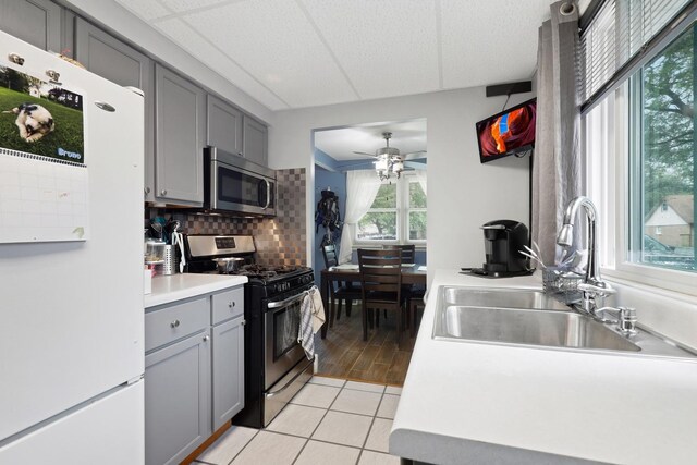 14453 Kolin Ave, Midlothian, IL 60445 - kitchen with appliances with stainless steel finishes, gray cabinetry, a sink, ceiling fan, and backsplash
