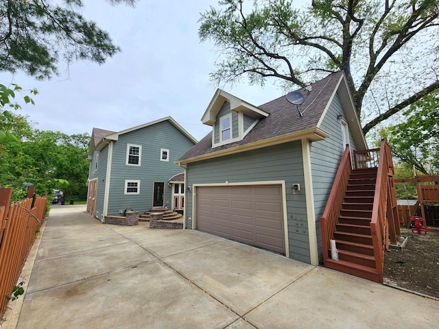 5115 E Ln, Mchenry, IL 60050 - view of property exterior with a garage, a shingled roof, driveway, and stairs