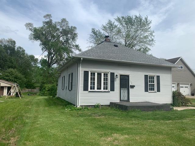 122 Portland Ave, Oglesby, IL 61348 - back of property featuring a yard, a chimney, and a shingled roof