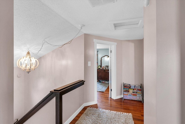 55 N 2600e Rd, Rankin, IL 60960 - hall with a textured ceiling, dark wood-type flooring, baseboards, and attic access
