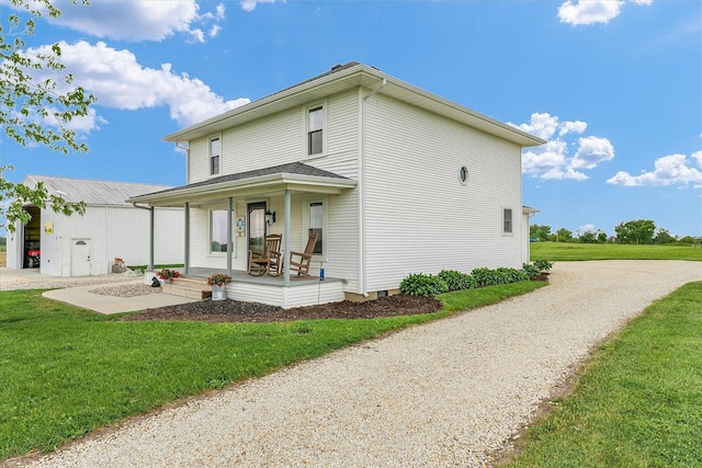 55 N 2600e Rd, Rankin, IL 60960 - view of home's exterior with a porch, a yard, and driveway