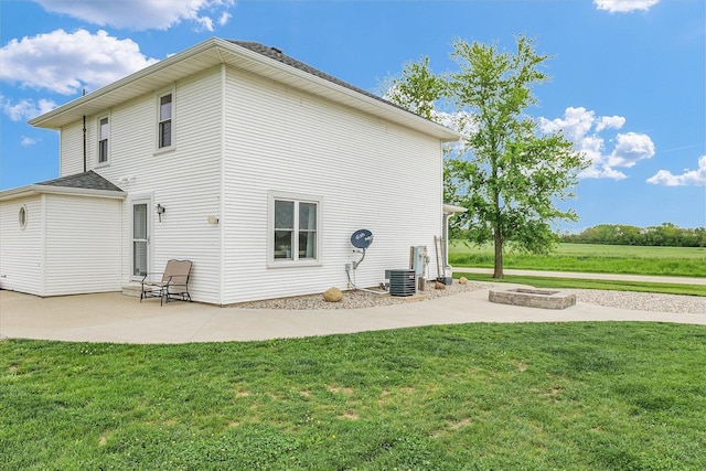 55 N 2600e Rd, Rankin, IL 60960 - back of property featuring a patio area, a yard, central air condition unit, and a fire pit