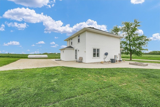 55 N 2600e Rd, Rankin, IL 60960 - rear view of property with a patio area, a yard, and central AC