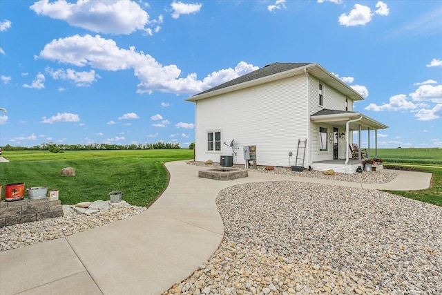 55 N 2600e Rd, Rankin, IL 60960 - view of side of property featuring a lawn, central AC unit, and a porch