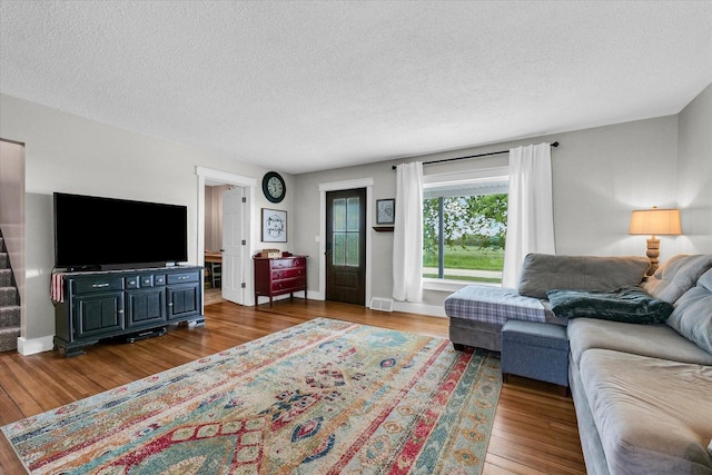 55 N 2600e Rd, Rankin, IL 60960 - living area featuring wood finished floors, a textured ceiling, and baseboards