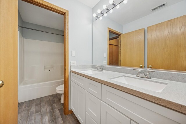 18582 W Point Dr, Tinley Park, IL 60477 - bathroom featuring toilet, double vanity, wood finished floors, and shower / washtub combination