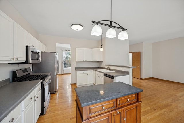 18582 W Point Dr, Tinley Park, IL 60477 - kitchen with stainless steel appliances, light wood-style flooring, a sink, white cabinetry, and dark countertops